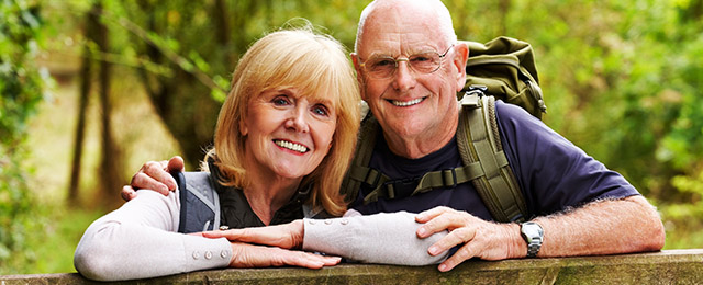 Older couple showing off their tooth implants that they received using tooth implant dentistry in Missoula.